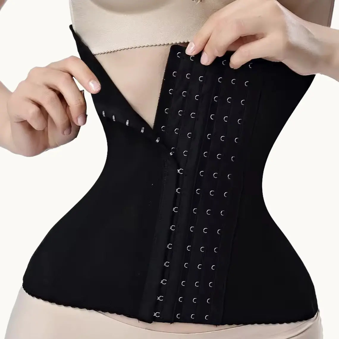 Black waist cincher hook-and-eye closure being adjusted